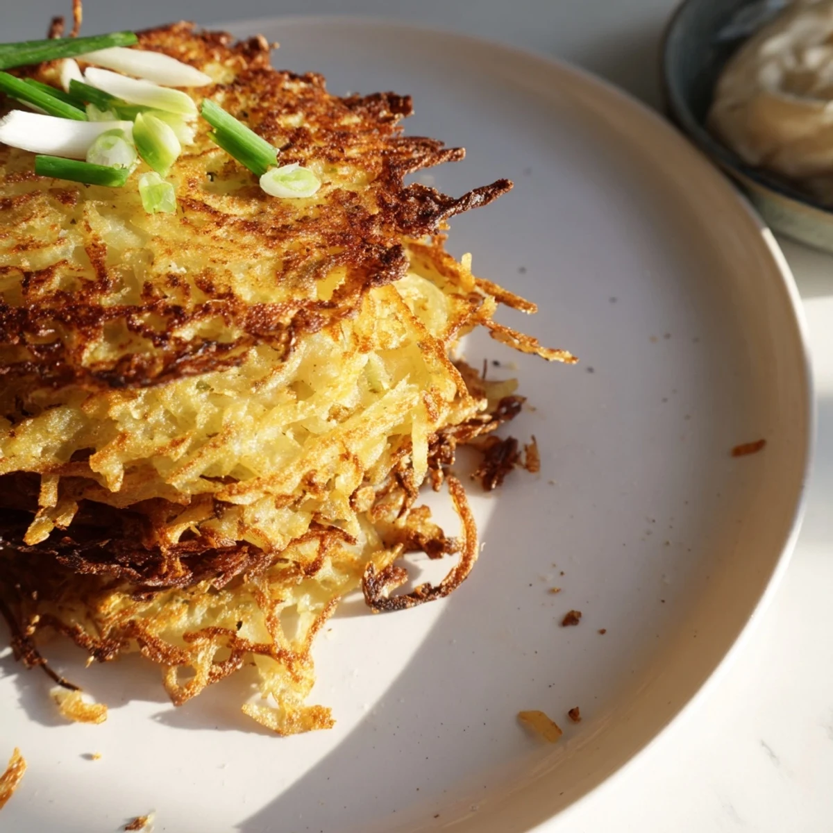 Savor the flavorful Kartoffelpuffer, featuring a creamy kimchi yogurt dip, perfect for snacking.