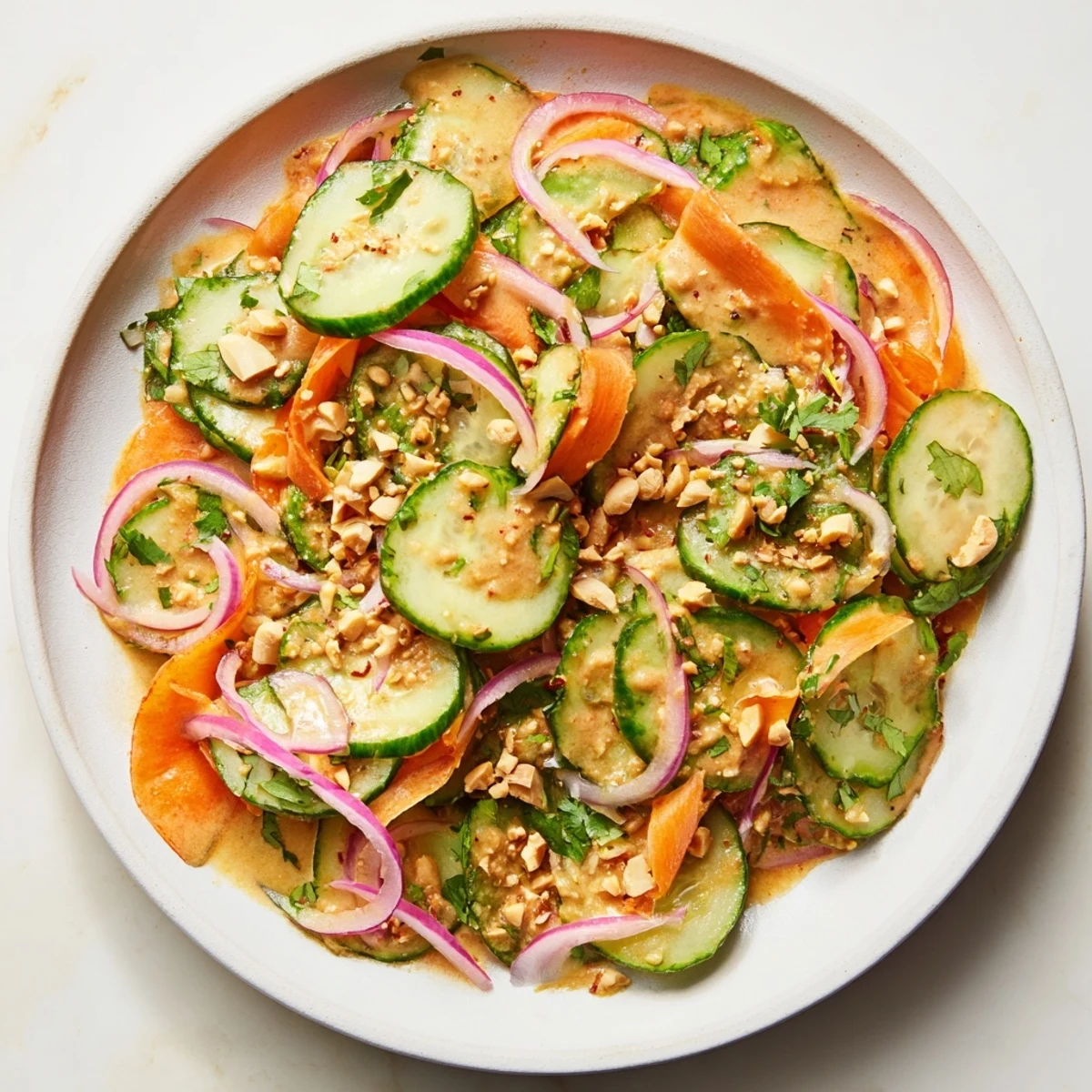 Crisp Thai-Style Peanut Cucumber Salad, with bright vegetables and creamy peanut dressing, ready to eat.