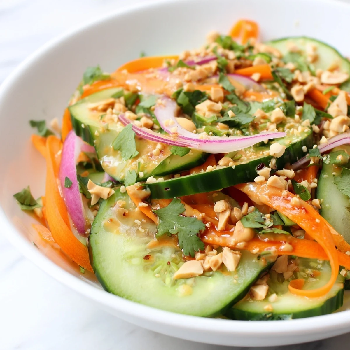 Close-up of the fresh Thai-Style Peanut Cucumber Salad, vibrant with colorful vegetables and peanuts.