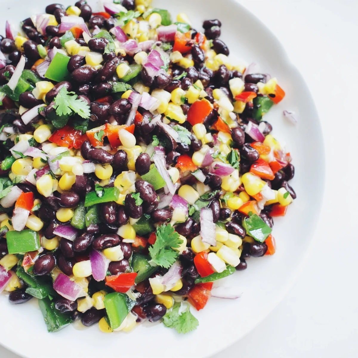 Close-up of fresh Cowboy Caviar Salad showcasing black beans, corn, peppers, and red onion; a perfect side.