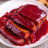 Steaming Vegan Sauerbraten with rich gravy and classic German side dishes.