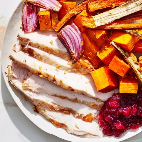 Golden-brown roasted harvest turkey platter, featuring tender turkey breast and vibrant autumn vegetables.