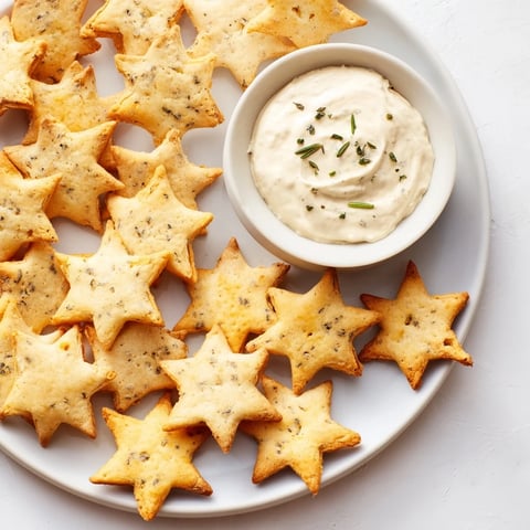 Crispy, golden Holiday Crackers, star shapes, perfect for your holiday appetizer spread with dip.