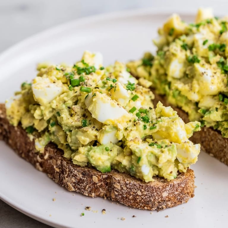 Freshly made avocado egg smash, garnished and ready to enjoy on whole-grain toast.