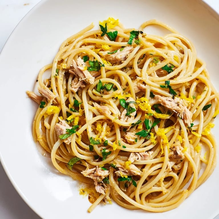 Flaky tuna and bright lemon zest mingle in this delicious lemon-garlic tuna spaghetti dish.