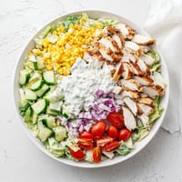 This vibrant Ranch Chicken Chopped Salad features tender chicken, crisp romaine, sweet corn, and sharp cheddar tossed in a creamy Greek yogurt ranch dressing.