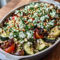 Roasted Veggie & Feta Couscous Bake fresh from the oven, featuring golden feta and caramelized Mediterranean vegetables.  